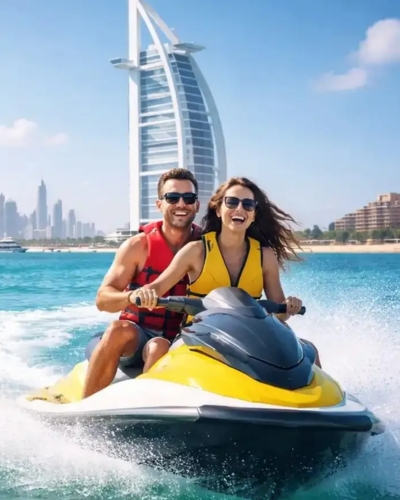 Couple riding jet ski near Burj Al Arab in Dubai