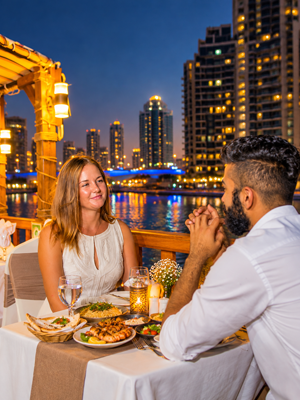 Dubai Marina dhow cruise featuring illuminated skyscrapers and scenic waterfront views at night